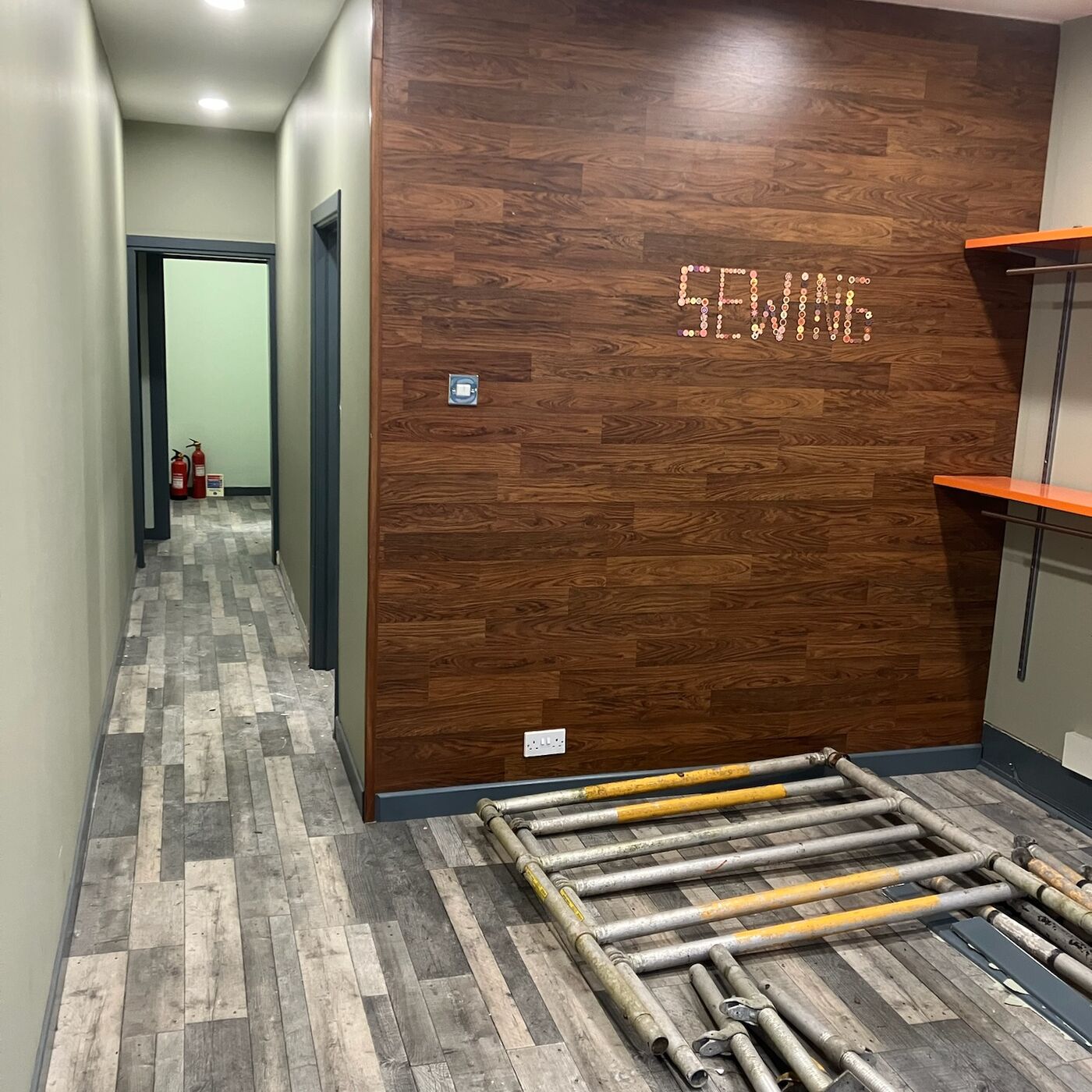 Same workshop finished, with wood-effect cladding wall and laminate floor